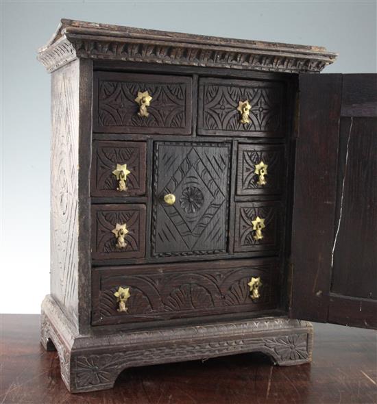 A carved oak cabinet, W.1ft 3in.